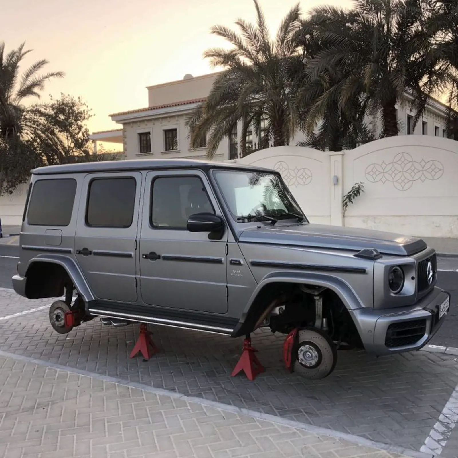 Mercedes G-Wagon on jack stands for on-site wheel service at a villa in Qatar